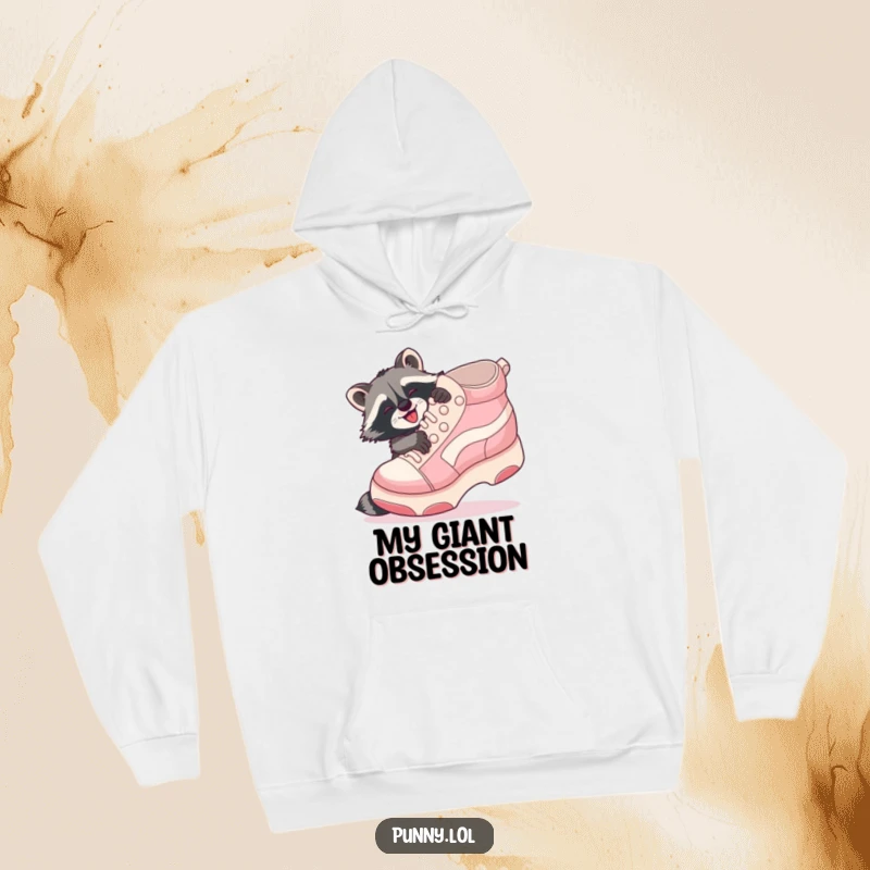 Funny Raccoon Shoe Hug Hoodie: A playful raccoon gleefully hugs a giant inflatable shoe, radiating cozy happiness.