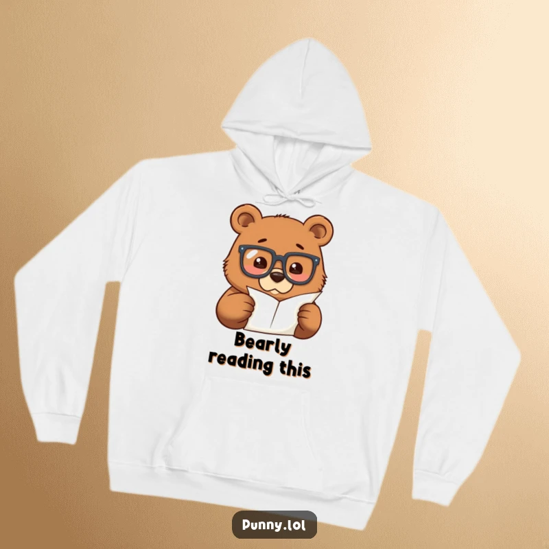 Funny hoodie with a focused bear wearing oversized glasses, studying a minuscule piece of paper, perfect for cozy intellectual moments.
