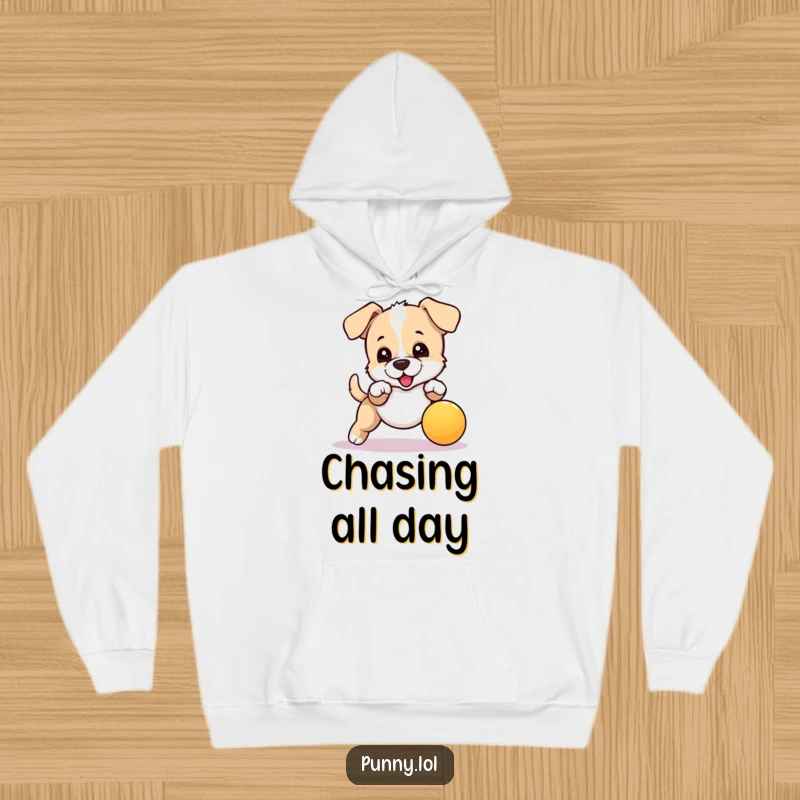 Funny hoodie displaying an energetic puppy mid-leap, trying to catch a bouncing ball, perfect for cozy and humorous vibes.