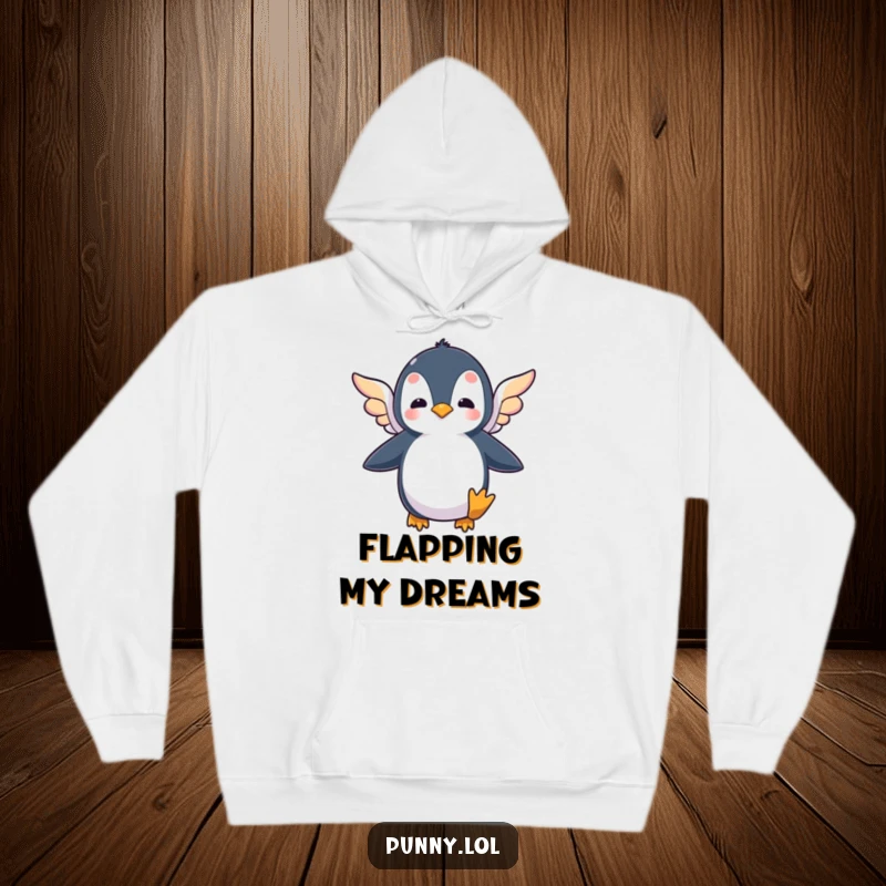 Funny hoodie featuring a silly penguin flapping tiny, colorful wings, symbolizing the humorous pursuit of flight and big dreams.