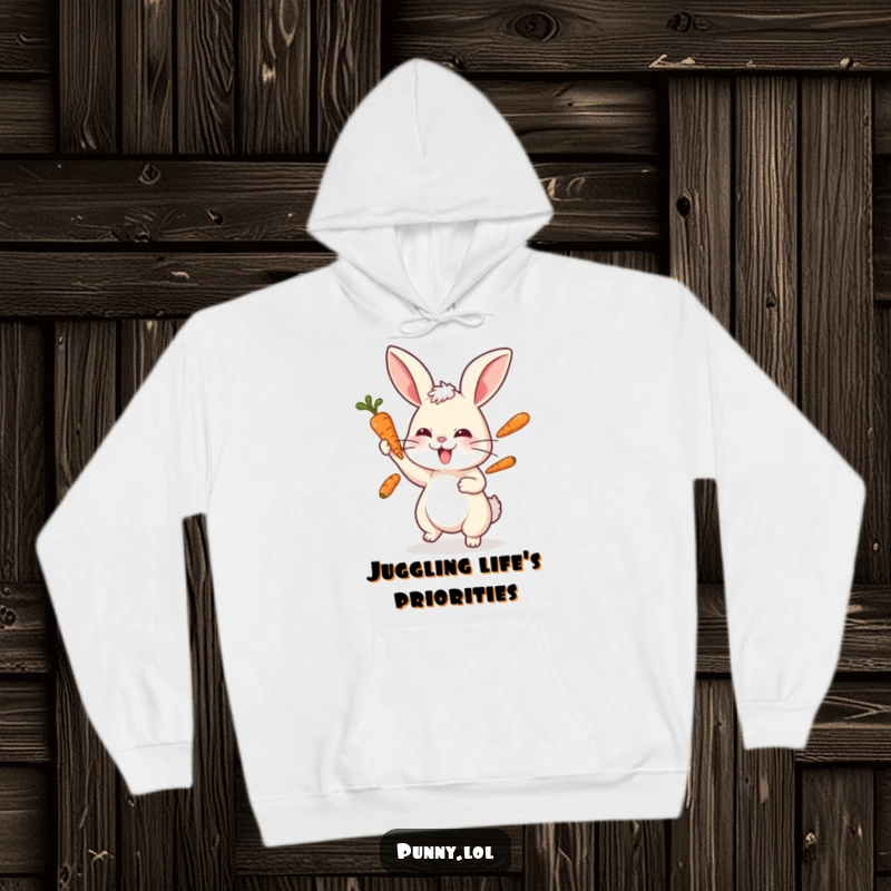 Funny rabbit hoodie showing a cute bunny focused on juggling three carrots, symbolizing skill and playfulness.