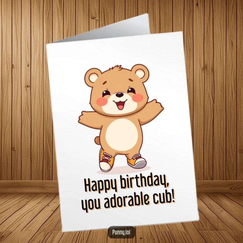 Funny Free Printable Birthday Card: A beaming bear cub joyfully hops around wearing two completely different, mismatched shoes.