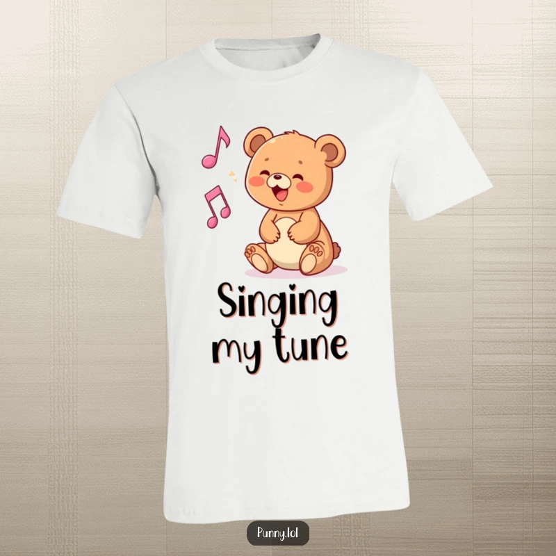 Funny t-shirt featuring a delighted bear cub playing with a floating musical note, perfect for music lovers.