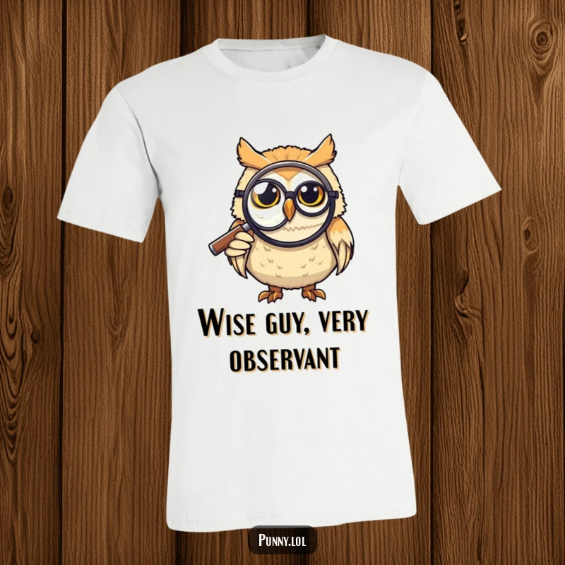 Funny T-Shirt: A grinning owl wearing a monocle peers intently through a giant magnifying glass, exuding intellectual humor, ideal for funny gift seekers.